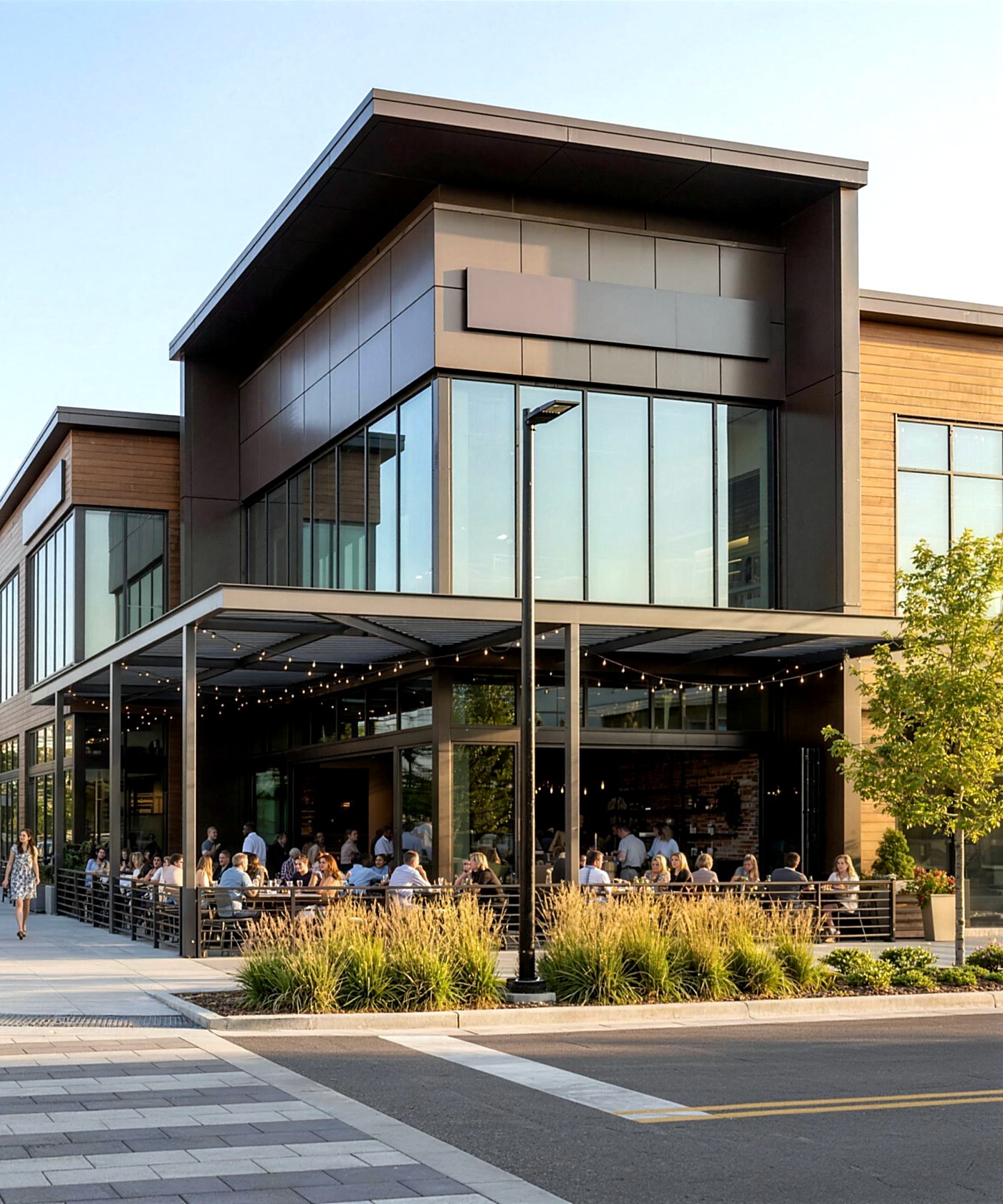 A modern lifestyle-center corner with a lively restaurant terrace